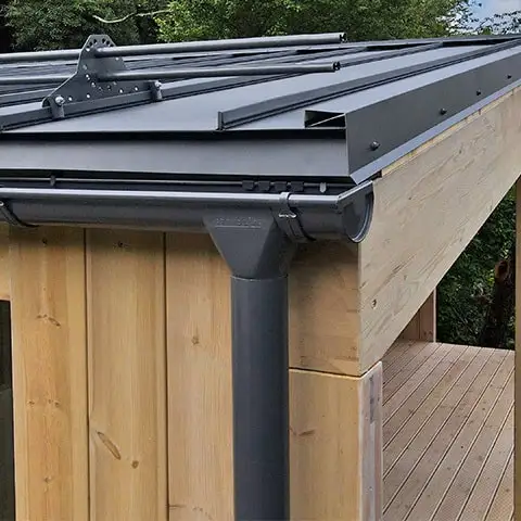 Водосточная система Grand Line 150×100 серого цвета на свесе дома